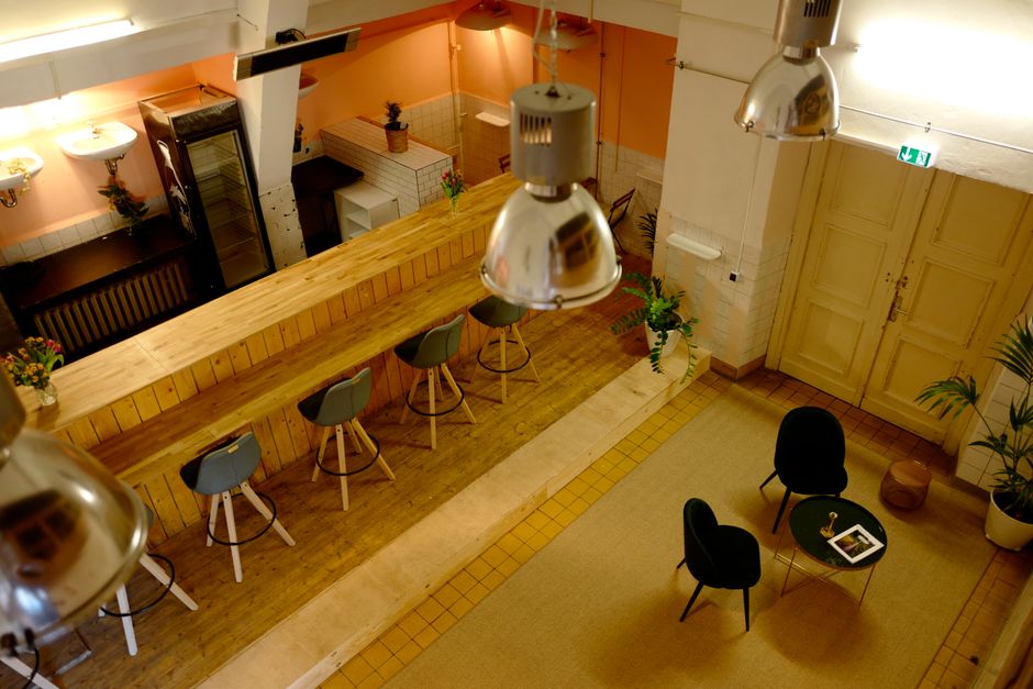 Modern bar interior with stools and seating area in Berlin, Germany.