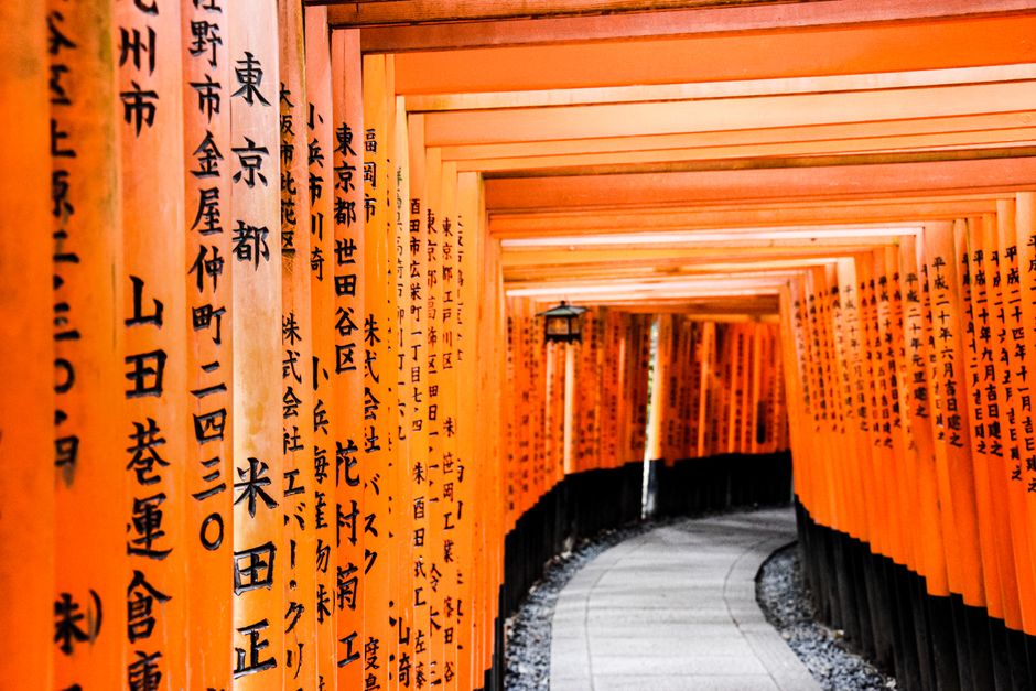 Explore the vibrant orange Torii gates of the Fushimi Inari Shrine in Kyoto, Japan, a stunning architectural landmark.