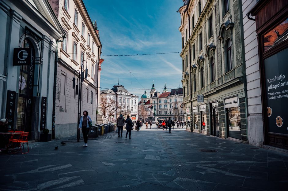 Urban street scene in Ljubljana, Slovenia with historic buildings and pedestrians.