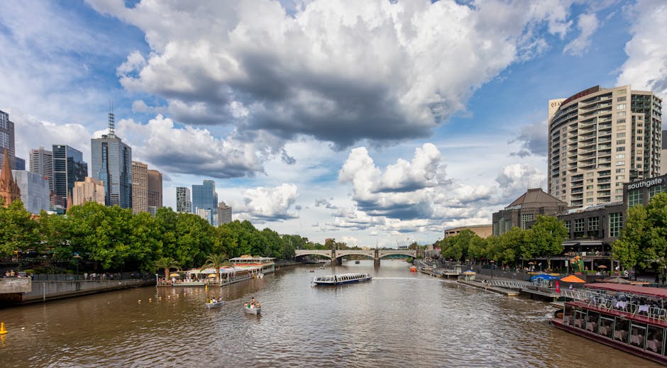 Stunning aerial view of Yarra River with Melbourne skyscrapers, Princes Bridge, and vibrant city life.