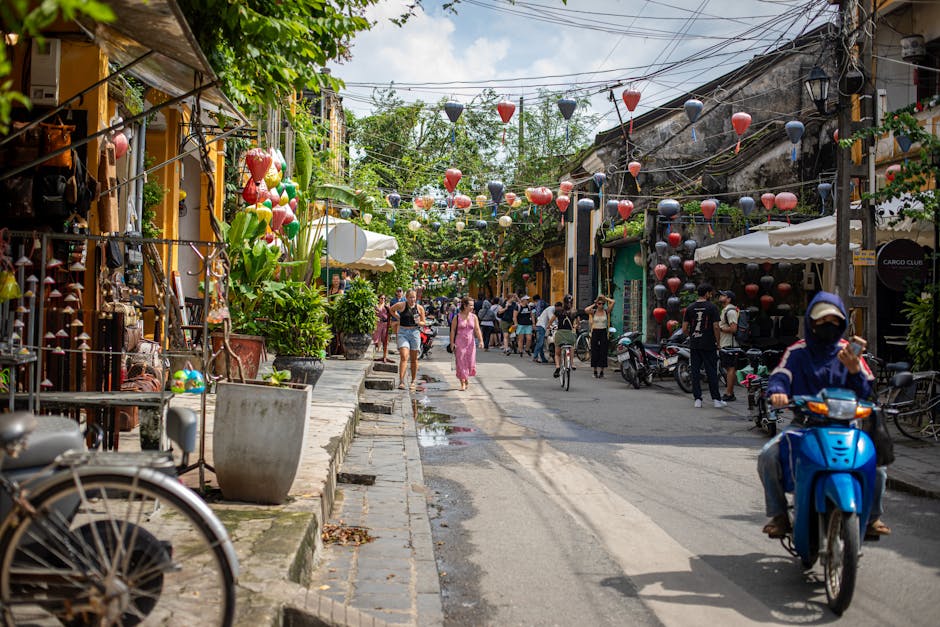 A lively street in Hội An, Vietnam, full of colorful lanterns and bustling with people.